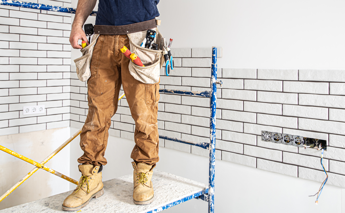 Professional worker assessing the progress of building renovation