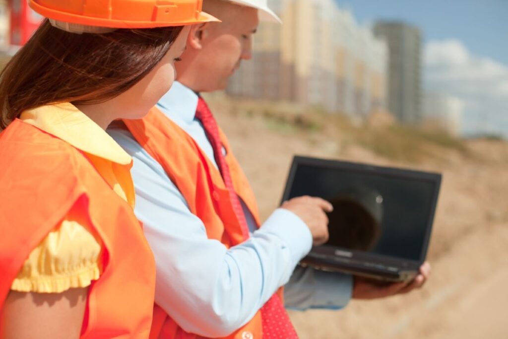 An engineer and a road crew doing site assessment