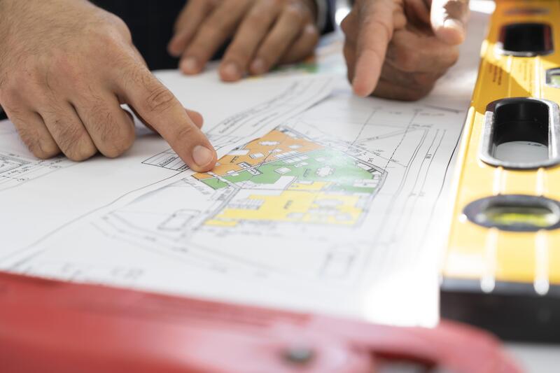 A person studying the commercial building construction plan.