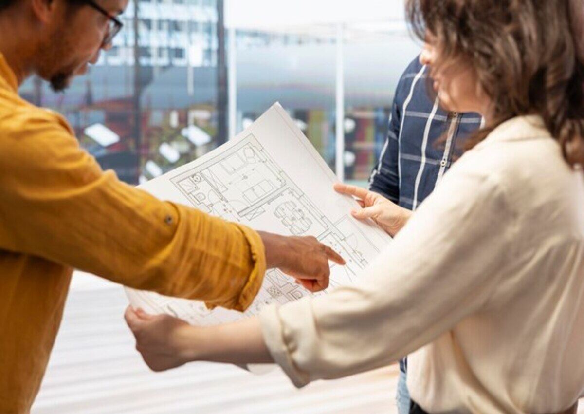 Contractor showing the open floor plan document to the business owner