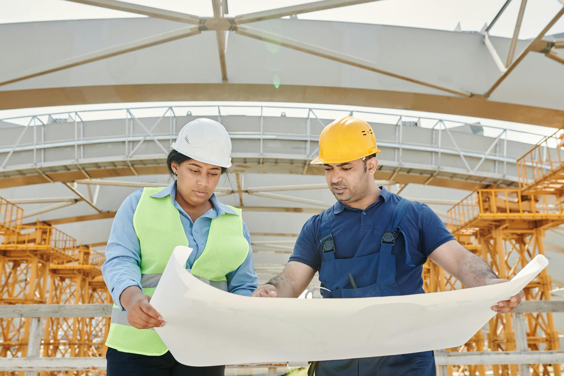 Two people analyzing the construction plan