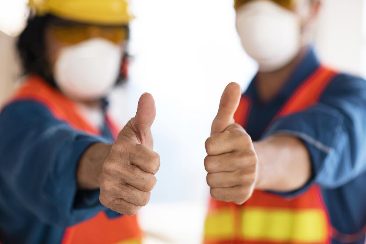 Commercial construction professionals giving a thumbs-up.