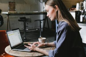 A woman using a laptop in a restaurant for remodeling