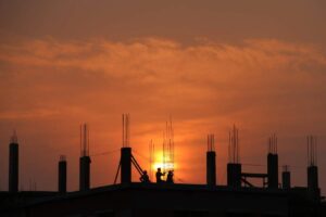 men in commercial building constructions site during sunset