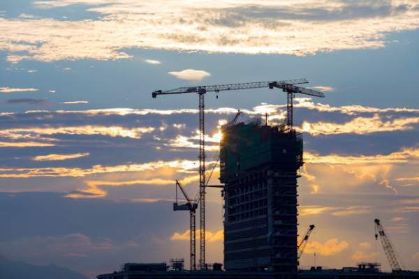 unfinished commercial building constructions with tower crane