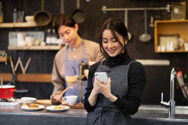 woman using her phone in a restaurant