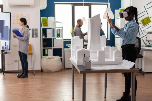 architect standing in modern architectural office using virtual reality goggles