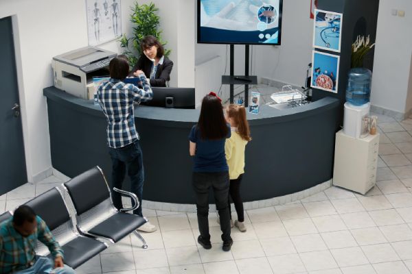 medical office reception and waiting area with diverse patients