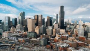 A panoramic view of a modern city skyline with high-rise buildings, symbolizing the final outcome of strategic land development and urban planning.