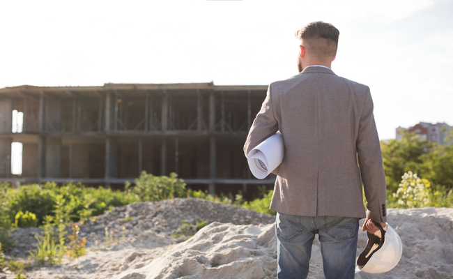 Construction project manager or developer evaluating an active site, embodying the core principles of land assessment and pre-construction planning.