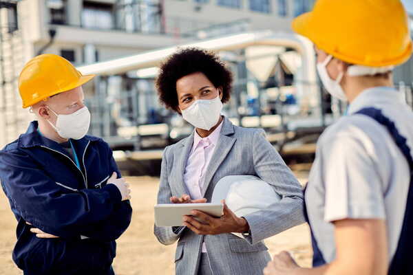 A woman talking to the site engineers