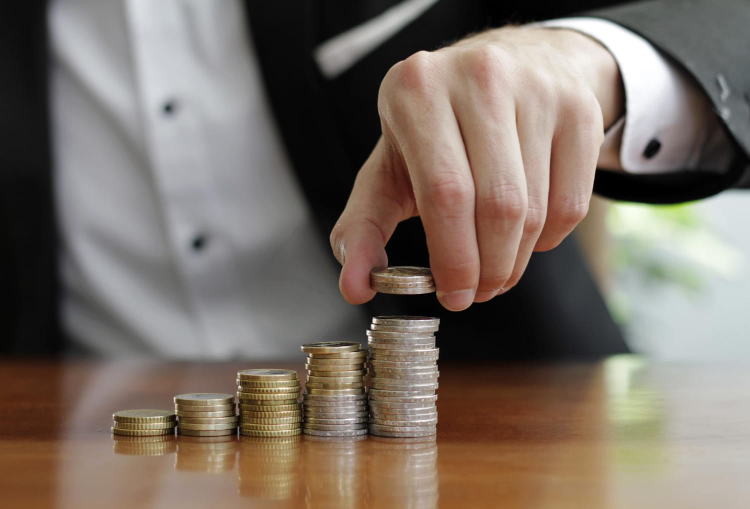 A Man Stacking Coins