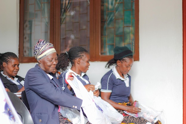 Mozambique caregivers holding new first aid kits provided by Van Brunt & Company
