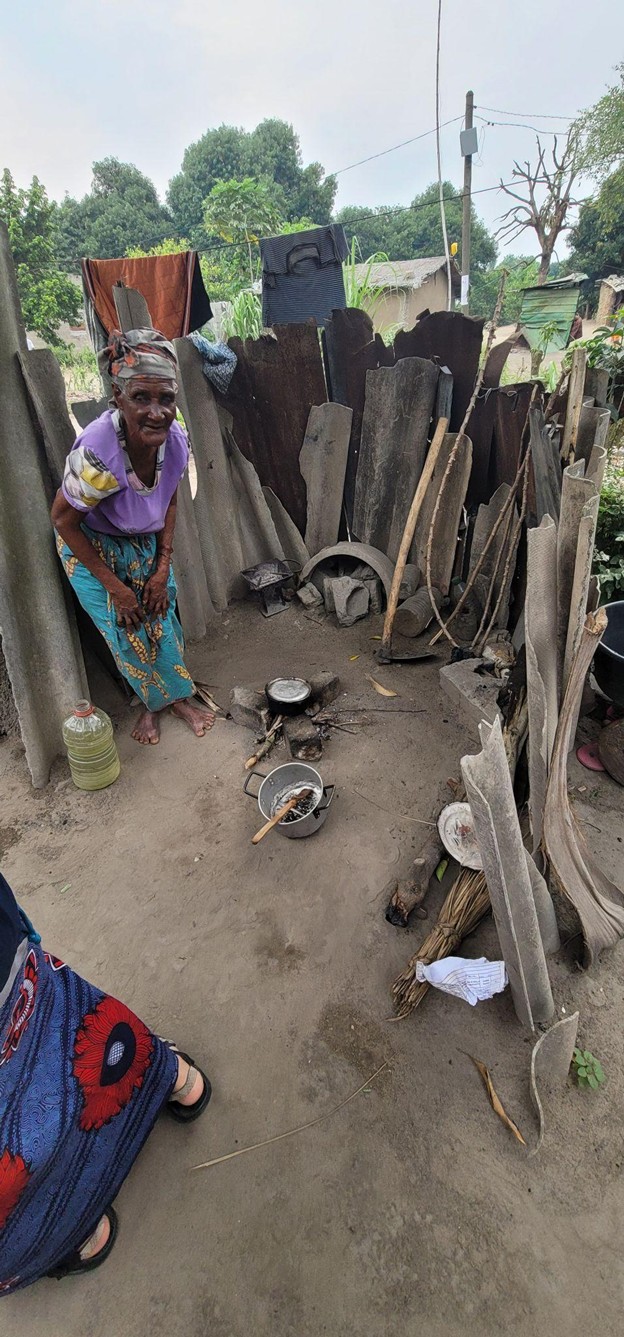 Widow being visited and cared for by community health volunteer in rural Africa_Van Brunt & Company